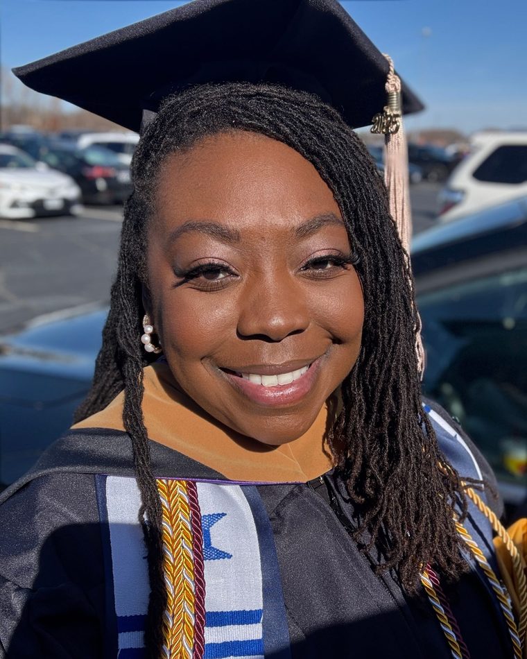 Brittany Davis Morris in her graduation cap, gown, and honor cords
