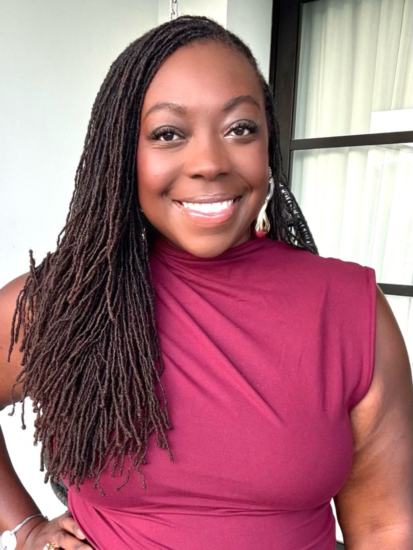 Brittany Davis Morris smiling, wearing a burgundy top