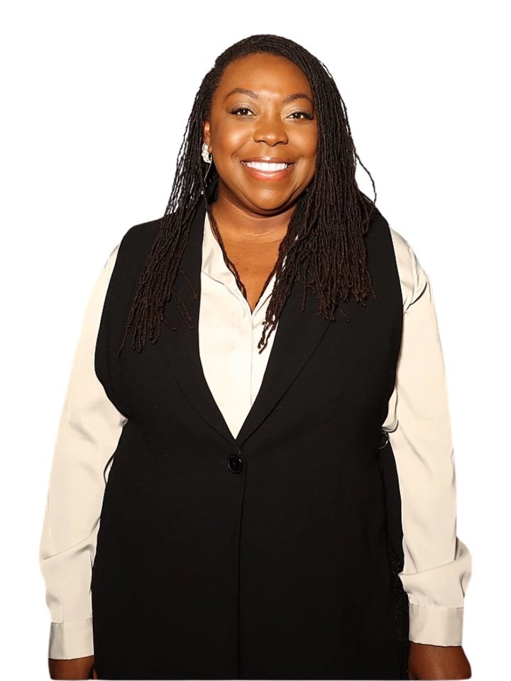 Brittany Davis Morris smiling, in a black vest over a cream blouse